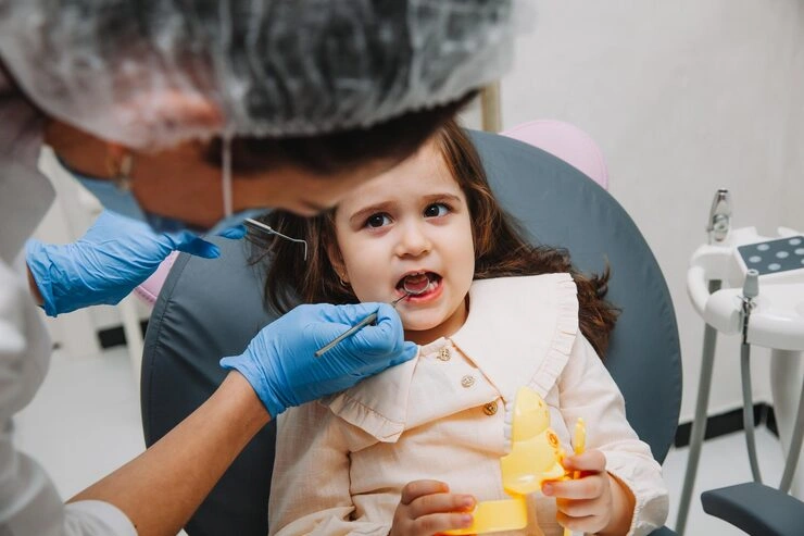 dentist doctor examines oral cavity little girl uses mouth mirror baby teeth close up concept pediatric dentistry dental treatment 132375 7512