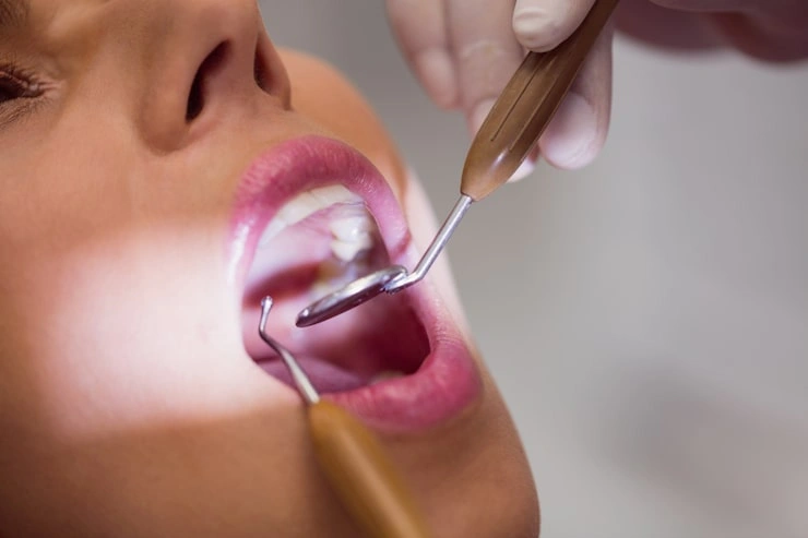 dentist examining female patient teeth 107420 65306
