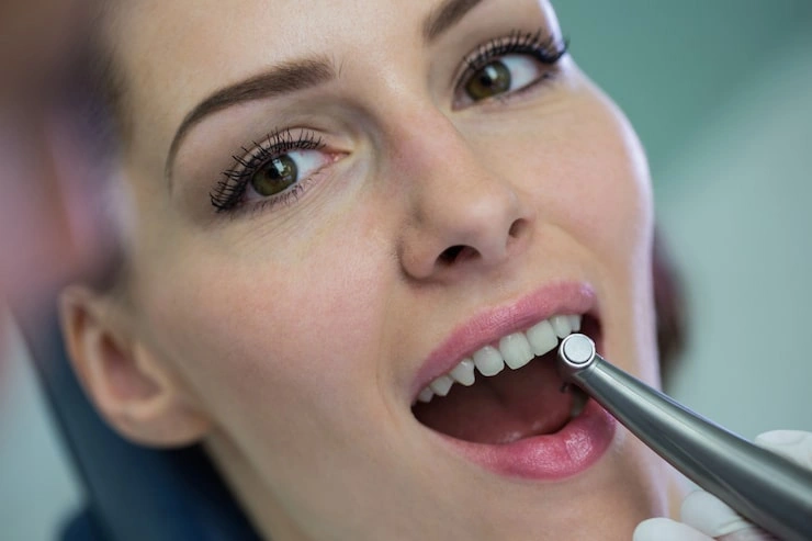 dentist examining female patient with tools 107420 74184