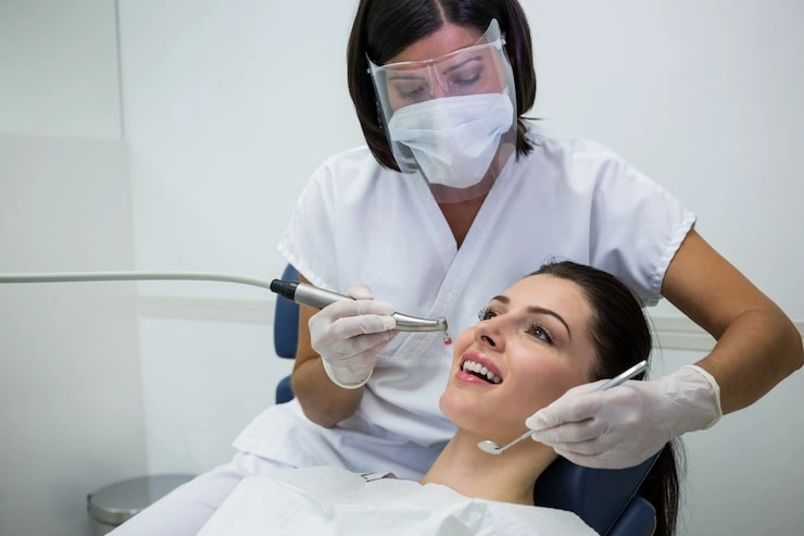 dentist examining female patient with tools 107420 74189