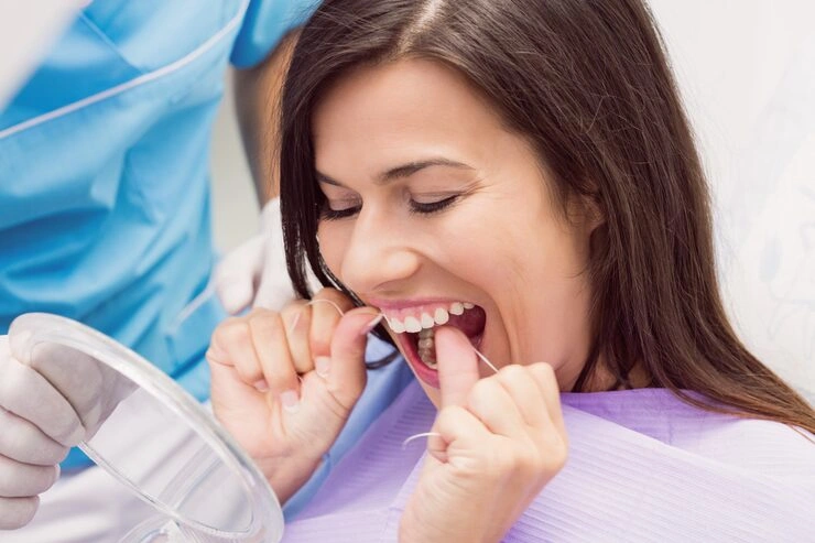 female patient flossing her teeth 107420 65471