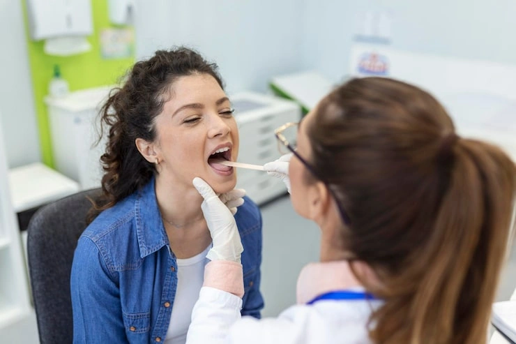 female patient opening her mouth doctor look her throat otolaryngologist examines sore throat patient 657921 181 1