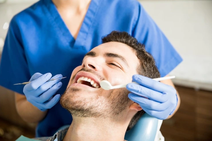 mid adult patient receiving dental treatment with tools from female dentist clinic 662251 2562